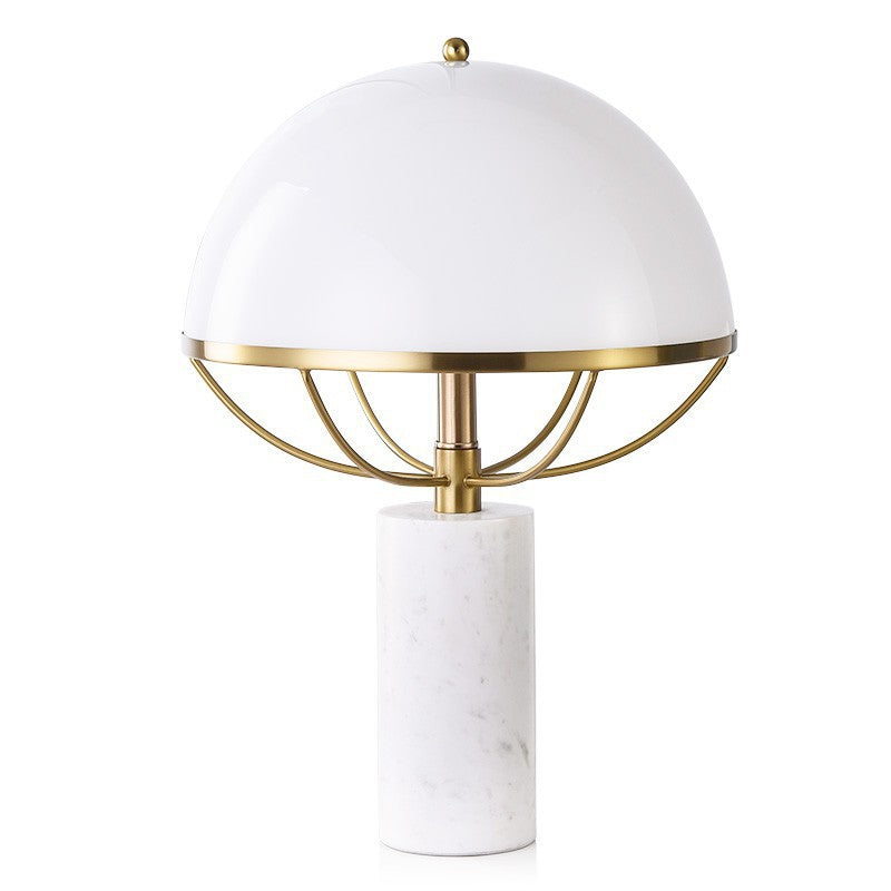 Gold cage detail beneath opal mushroom shade with marble base