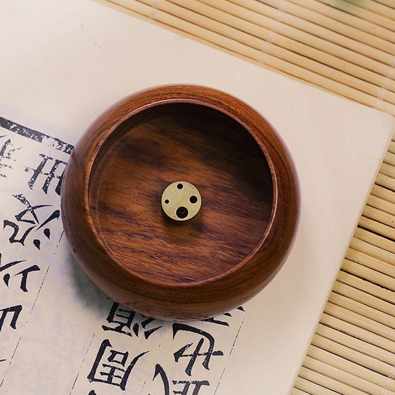 Mini round wood incense bowl with brass multi-hole insert styled on calligraphy paper