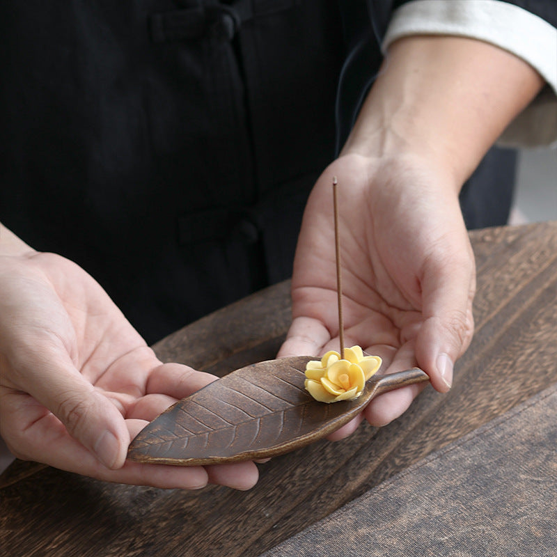 Handheld leaf shaped ceramic incense holder with yellow osmanthus flower