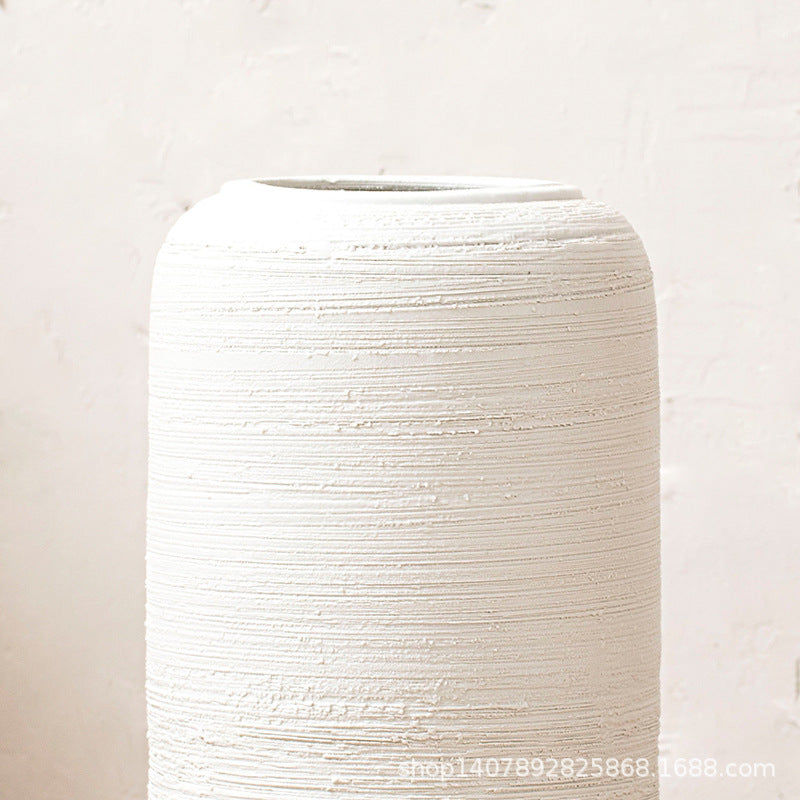 Close-up of ivory white horizontal ribbed ceramic floor vase surface