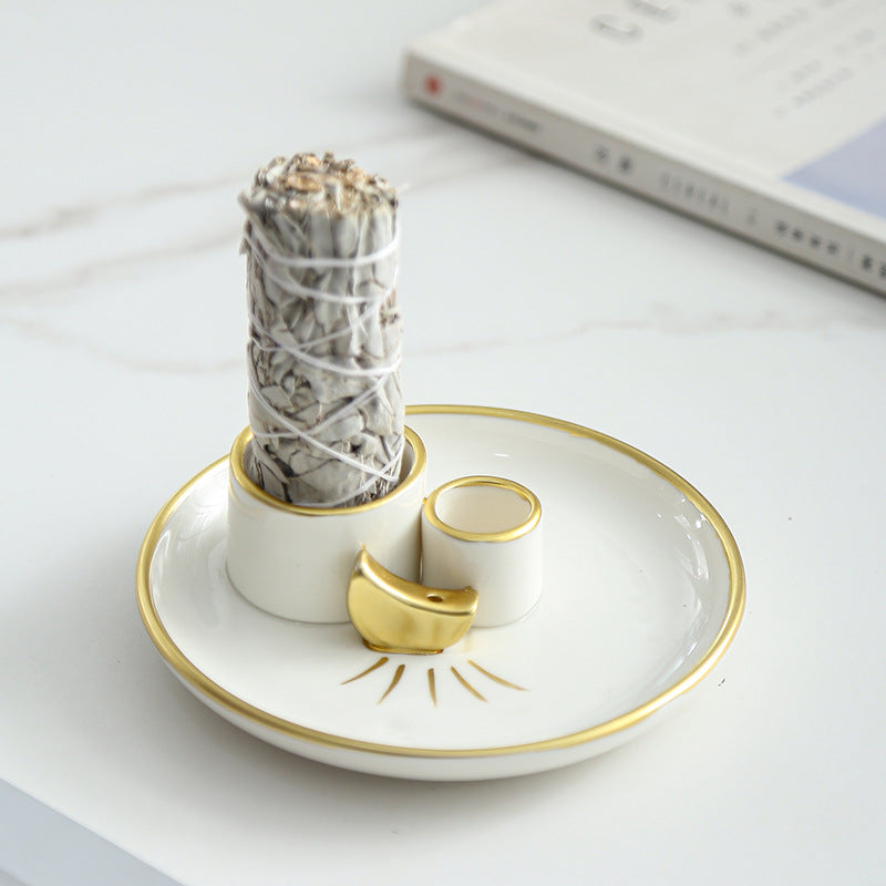 Ivory gold ceramic ritual tray holding a sage bundle for smudging
