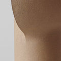 Textured sand beige resin sculptural table lamp surface detail