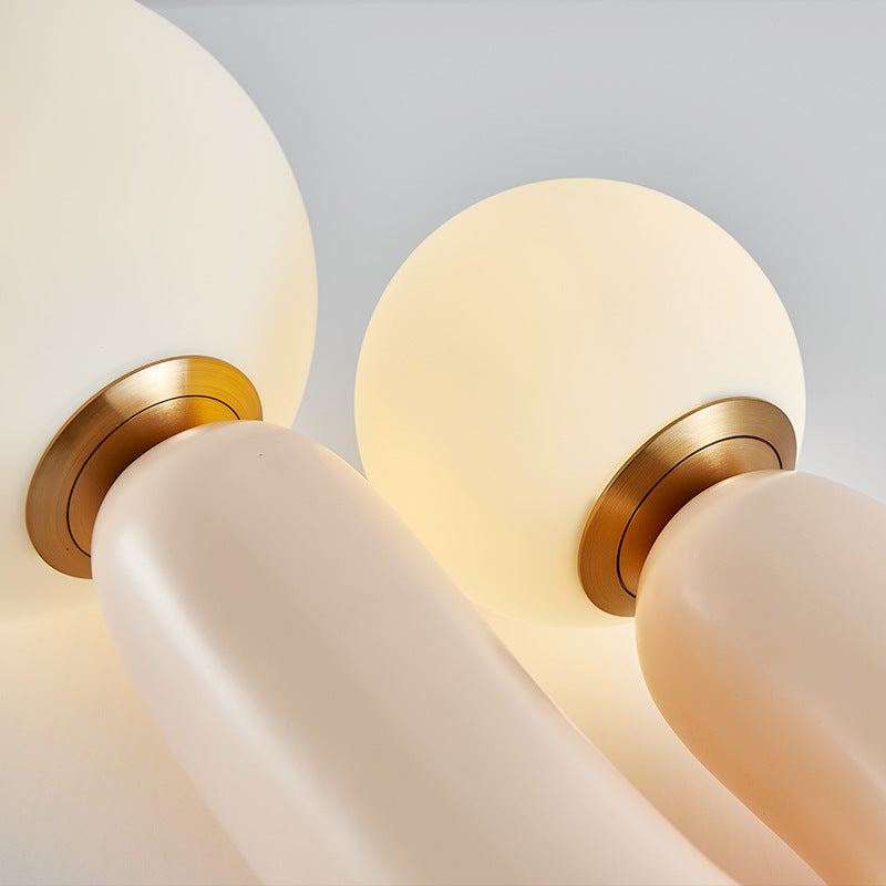 Dual globe sculptural table lamp with warm white glass spheres and gold accents