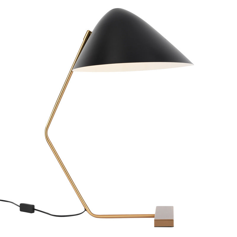 Gold angular frame and black cone shade table lamp side view