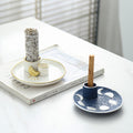 Ivory gold and midnight blue ceramic ritual trays styled with sage and Palo Santo