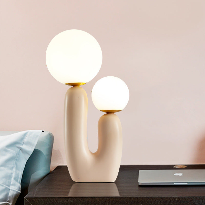 Dual globe sculptural lamp styled on modern bedside table