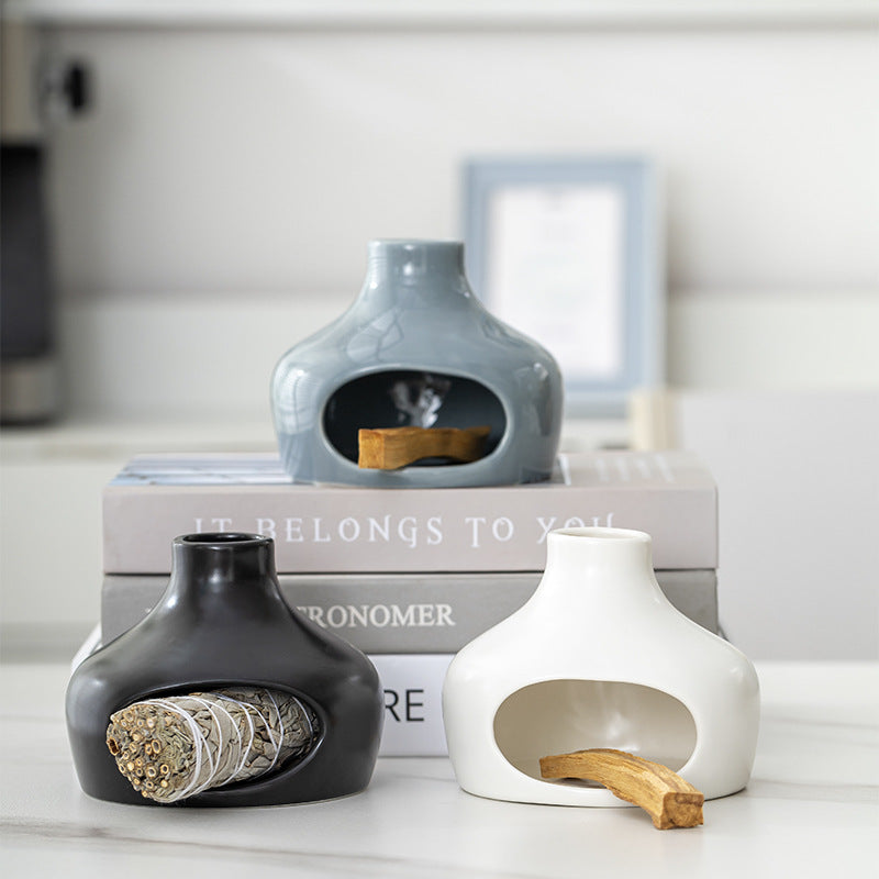 White black and blue ceramic Palo Santo holders styled with sacred wood and sage
