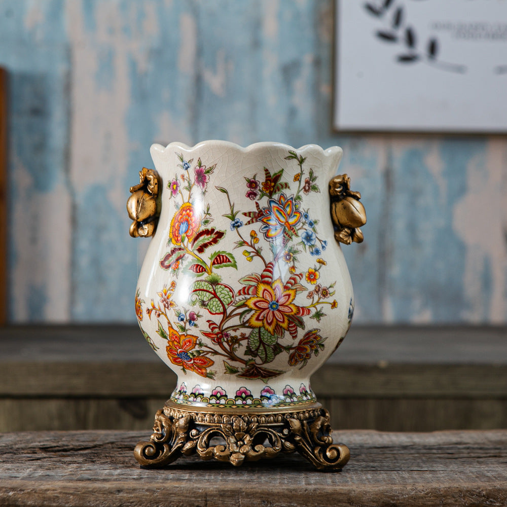 Vintage European ceramic vase with multicolor botanical pattern and ornate bronze-tone resin base