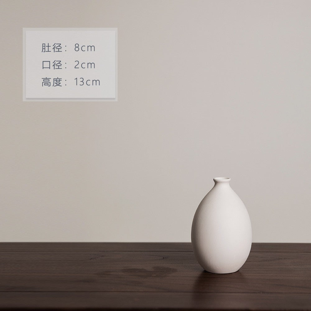 Matte ivory egg-shaped ceramic bud vase, 13 cm high