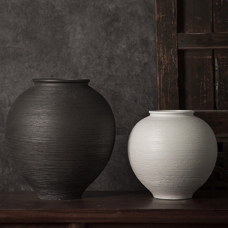 Black and white ribbed round ceramic vases paired for contrast styling