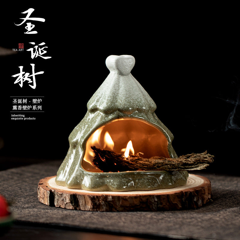 Christmas tree ceramic sage burner with flame glowing in front chamber