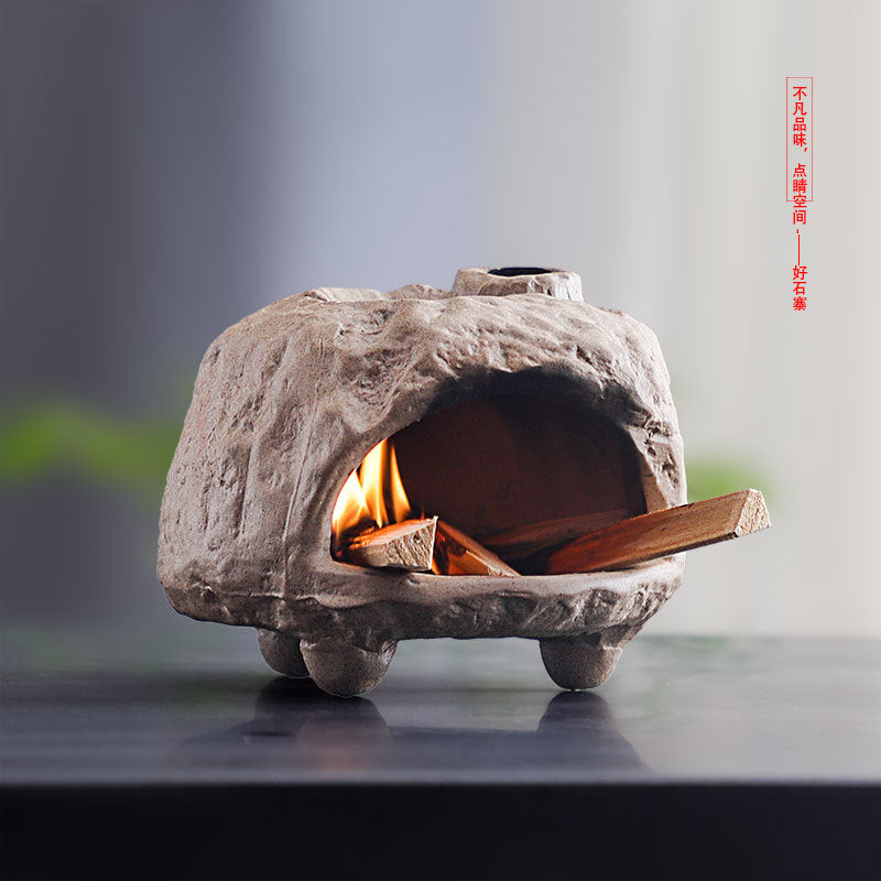 Natural stone cave sacred wood burner glowing during ritual use