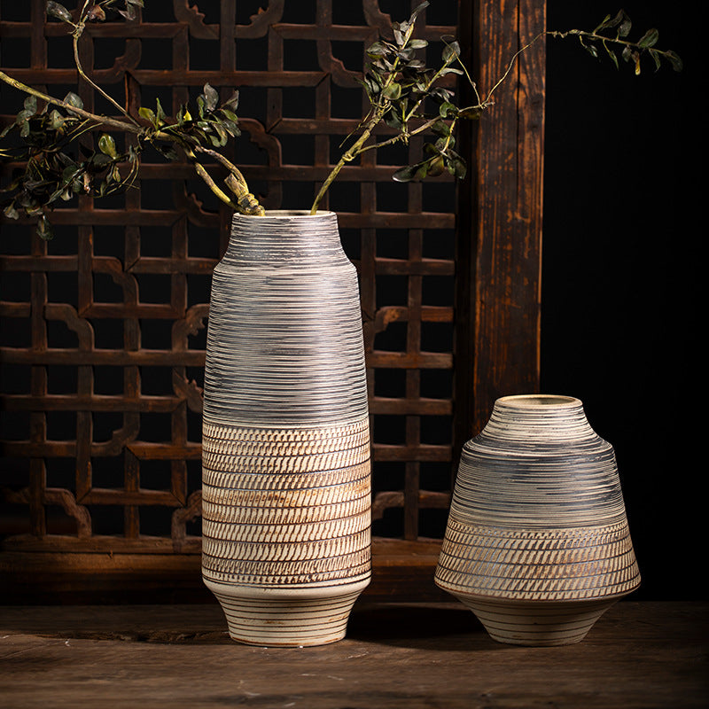 Large and small grey ochre textured ceramic vases with branches