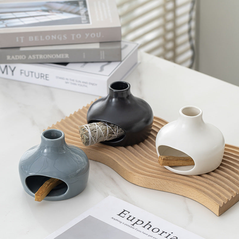 Ceramic Palo Santo and sage burners in white black and blue grey styled on wood tray