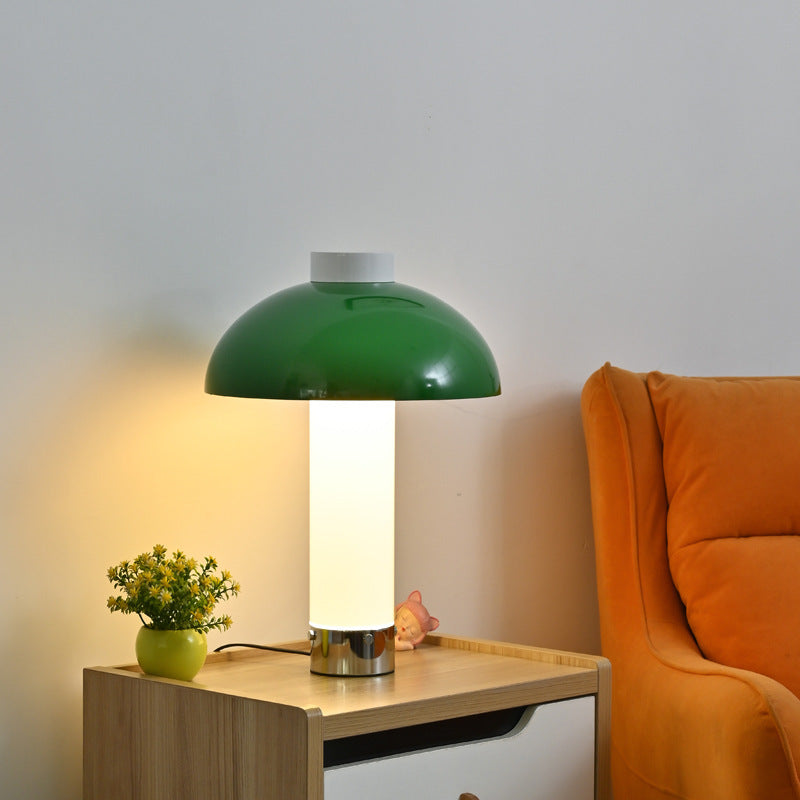 Beige pink dome table lamp styled beside sofa