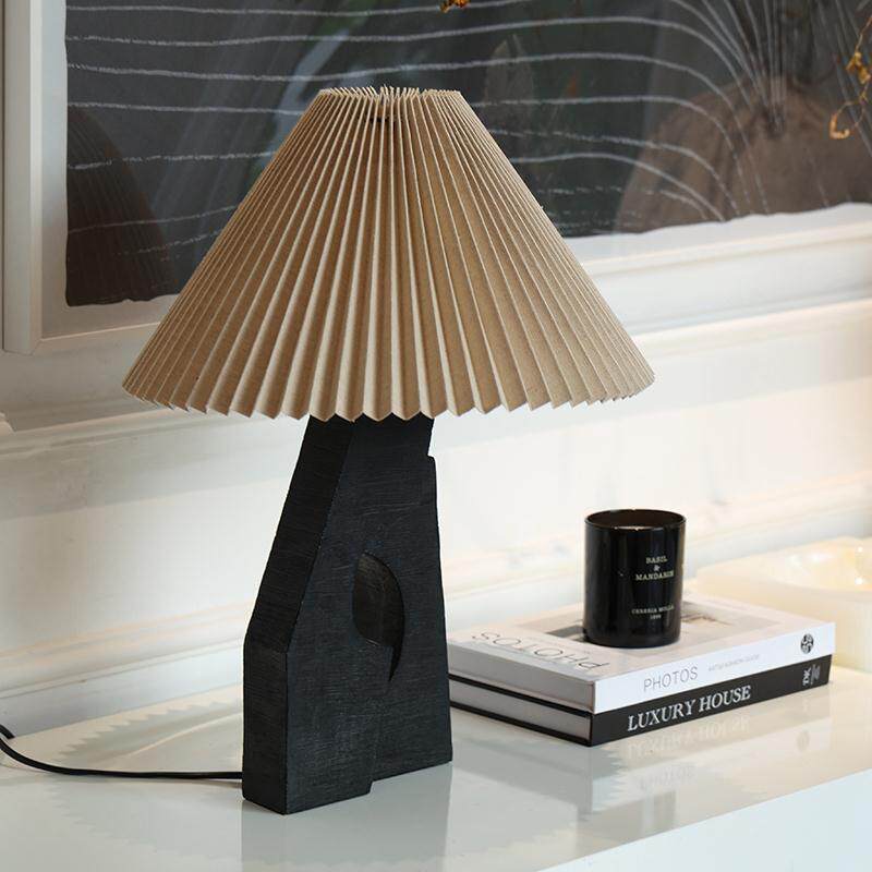 Black sculptural resin table lamp with pleated fabric shade