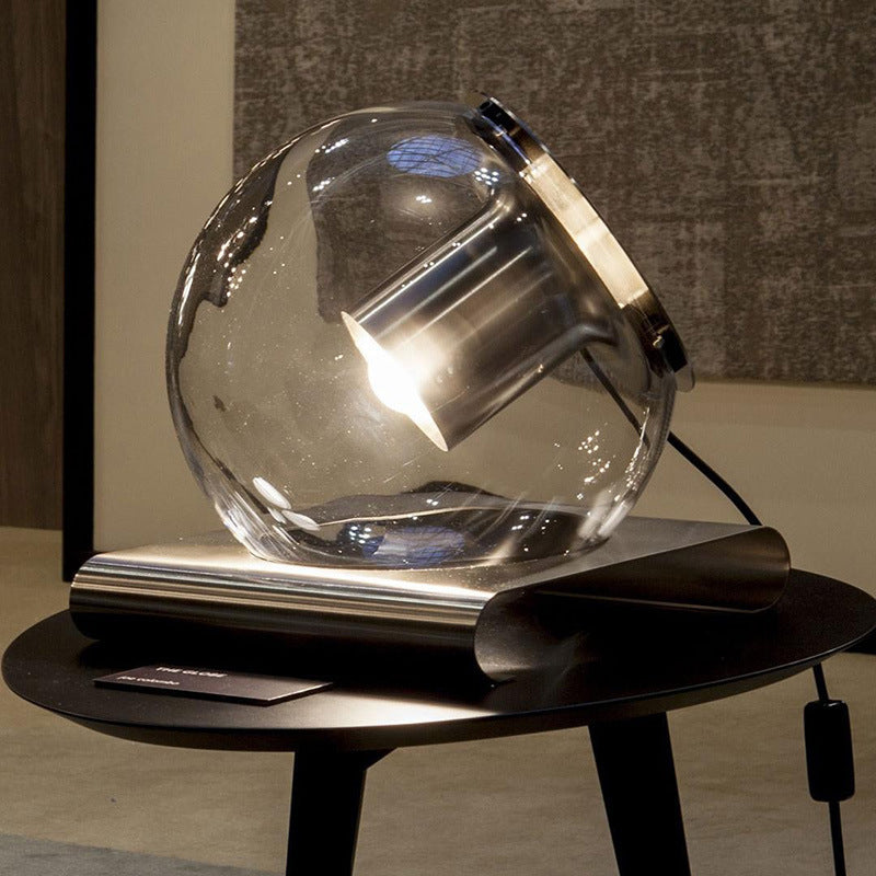 Glass globe table lamp styled on dark wood console