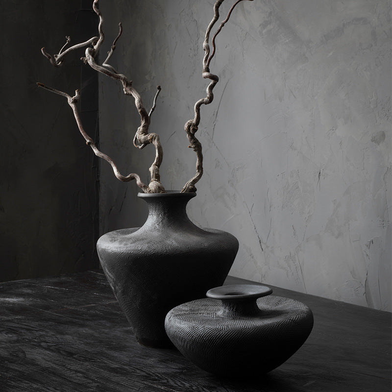 Tall black minimalist ceramic flower vase styled with dried branches
