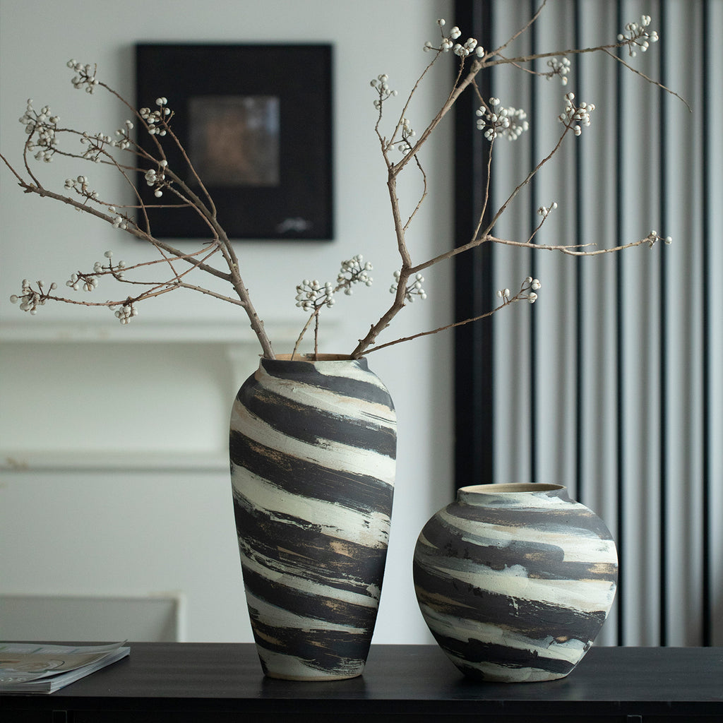 Tall and rounded charcoal cream striped ceramic vases in modern Chinese interior