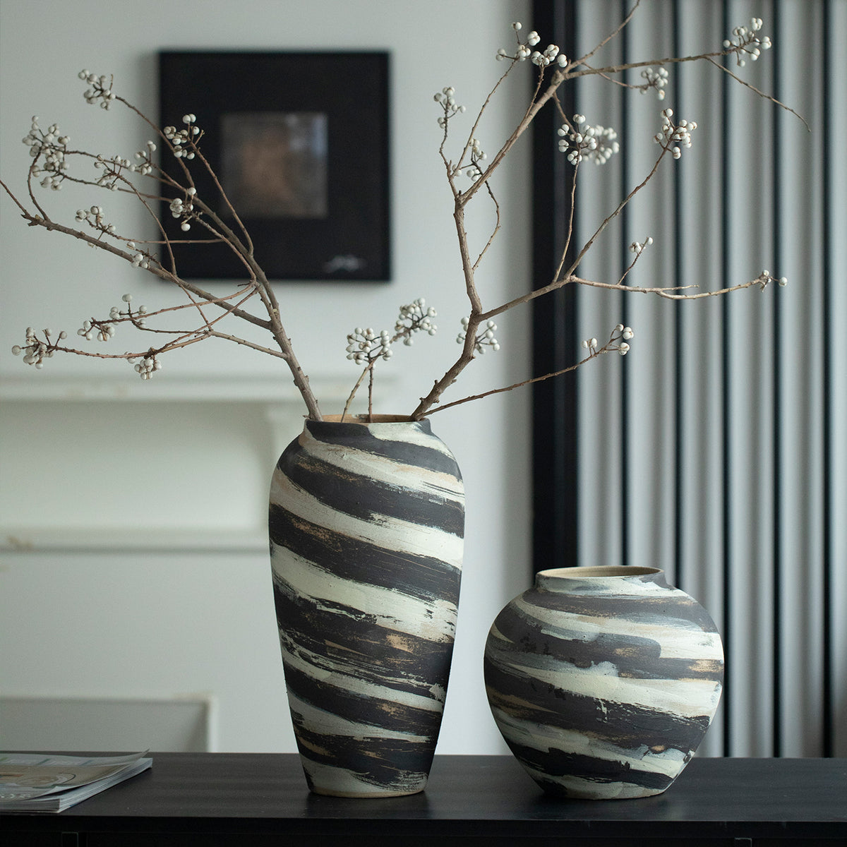 Tall and rounded charcoal cream striped ceramic vases in modern Chinese interior