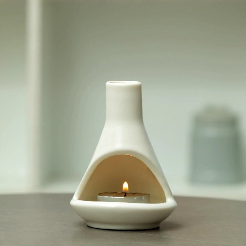 Minimal cream ceramic chimney incense burner with flame in front chamber