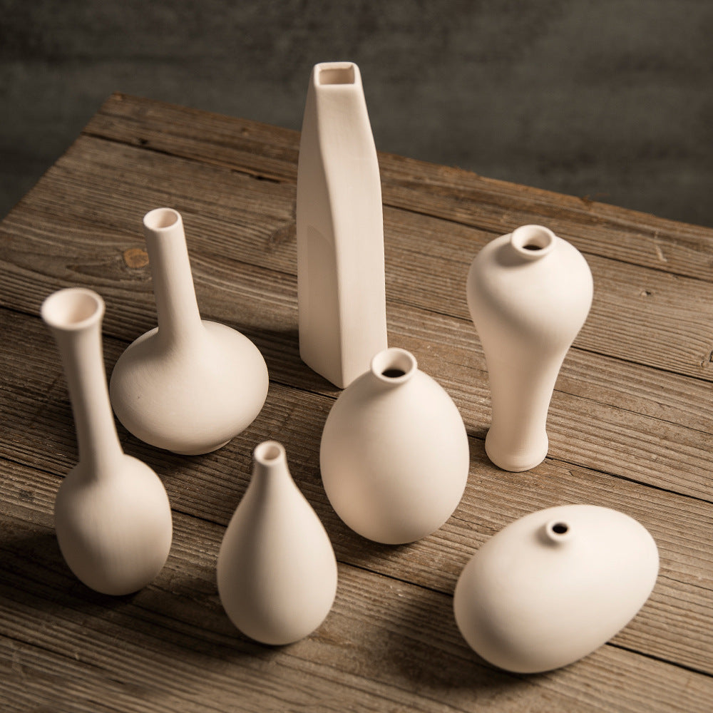 Matte ivory mini ceramic bud vase collection arranged together