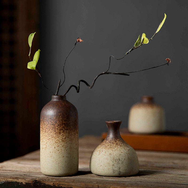 Tall bottle and pear-shaped brown-to-cream mini vases with branch