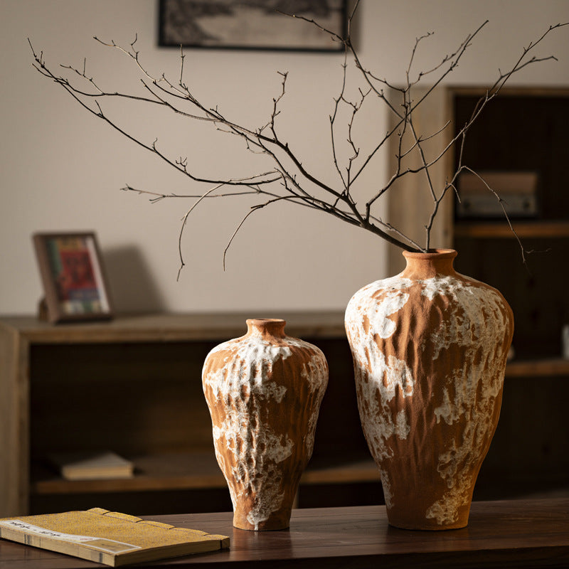 Small and large orange white rustic ceramic vases styled together
