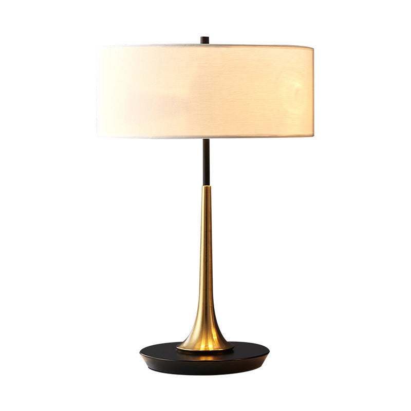 Small black and brass bedside lamp with ivory cylindrical fabric shade