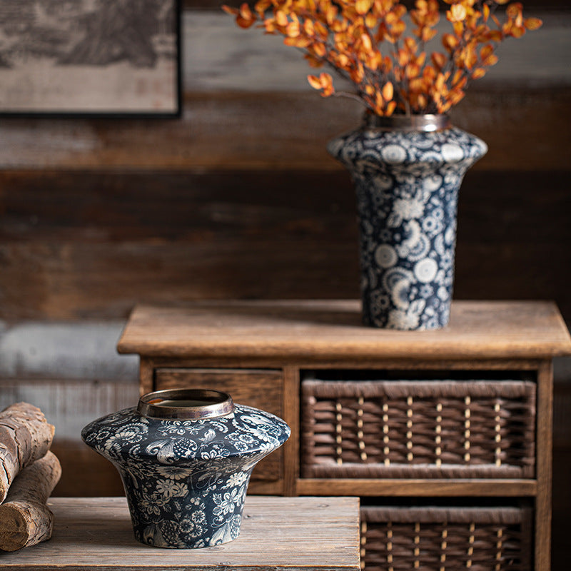 Dark indigo floral flared-shoulder ceramic vase in rustic interior