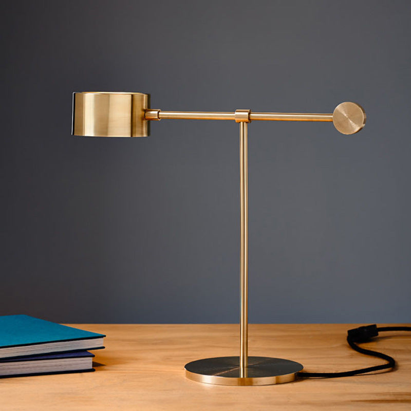 Gold linear task lamp with acrylic diffuser and weighted black base
