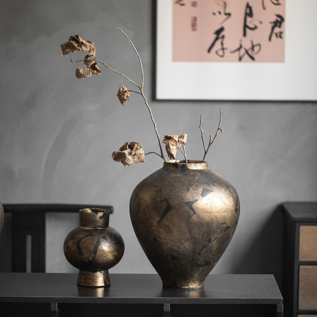 Black gold crackle ceramic vase pair styled beneath calligraphy art