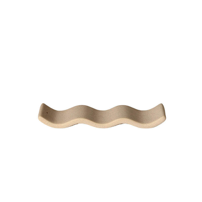 Deep coffee wavy ceramic incense tray isolated on white background