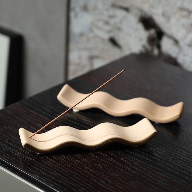 Light sand and milk white wavy ceramic incense holders styled together