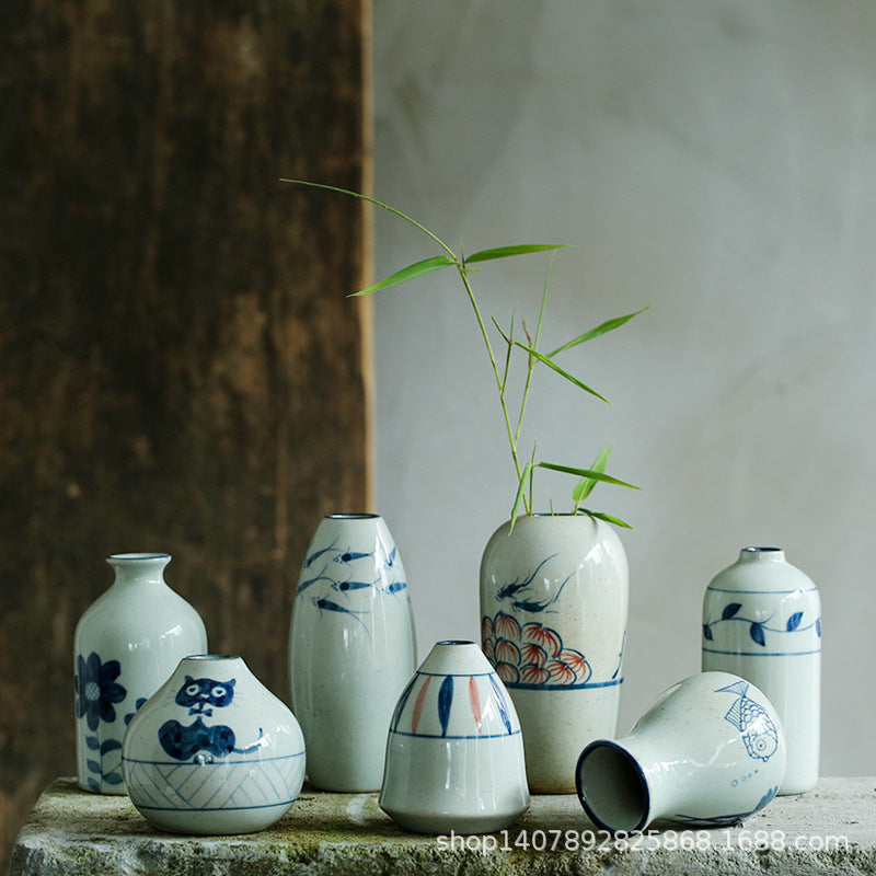 Hand-painted blue white folk art ceramic vase collection styled together