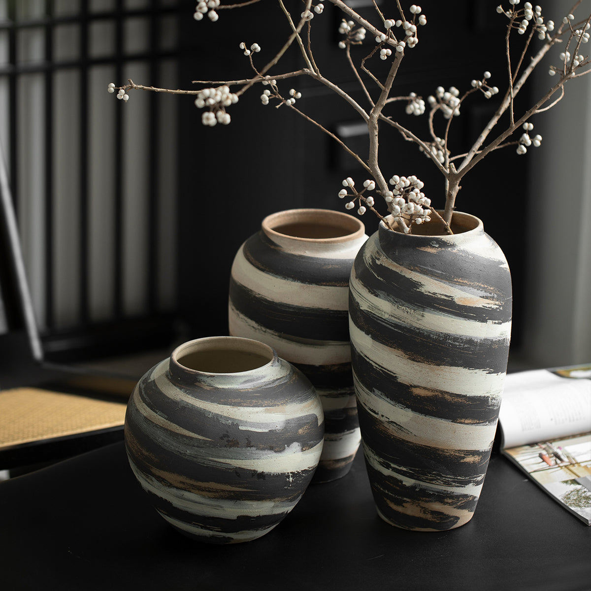 Rustic charcoal and cream brushstroke ceramic vase trio styled with branches