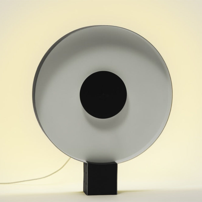 Round flying saucer designer table lamp with pale reflector and black center