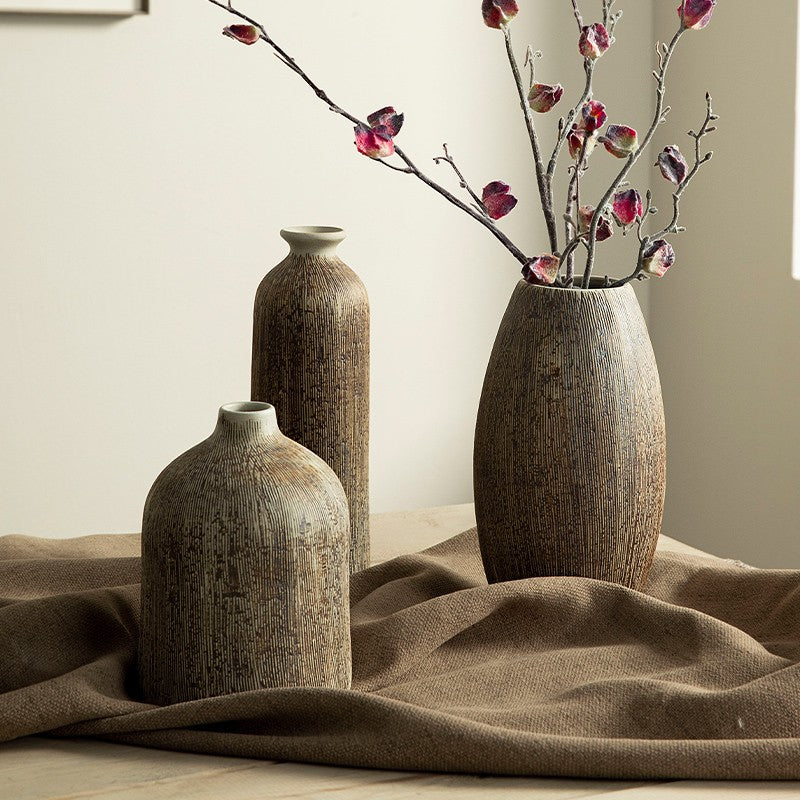 Three carved ceramic vases in complementary shapes