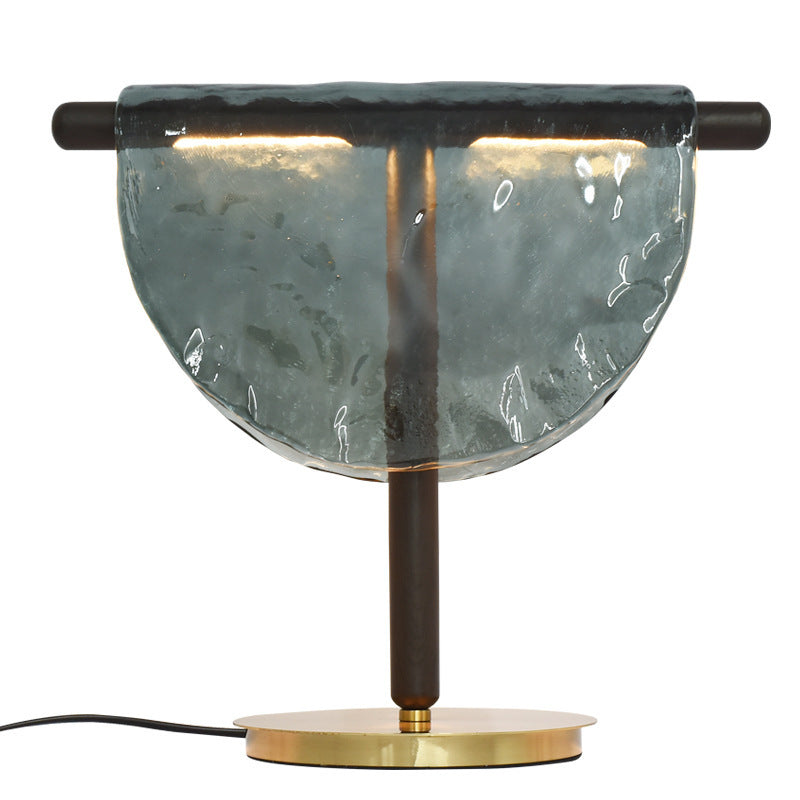 Smoke grey half moon glass table lamp styled on marble side table