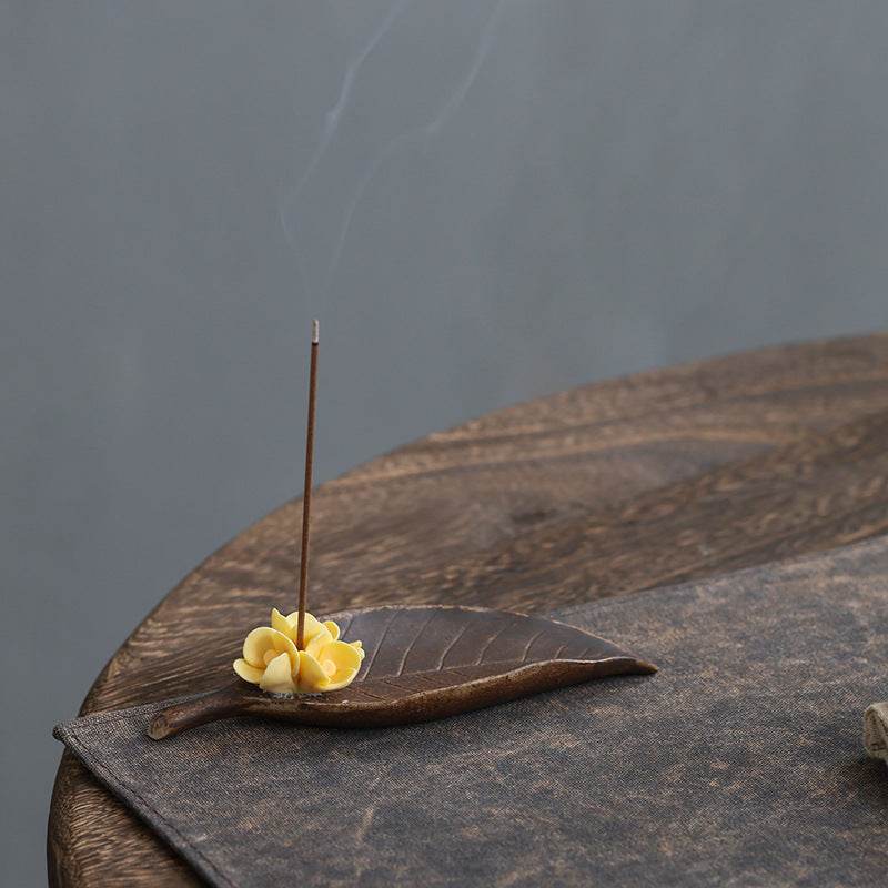 Brown leaf and yellow osmanthus flower incense holder with rising incense smoke