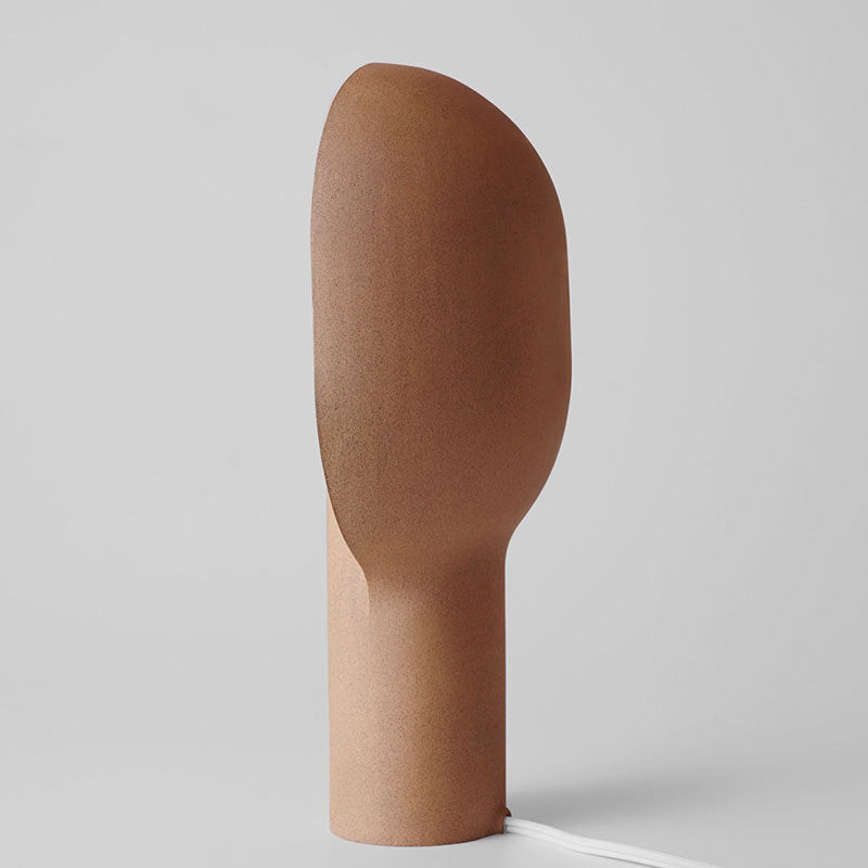 Side profile of sand beige resin table lamp with organic rounded form