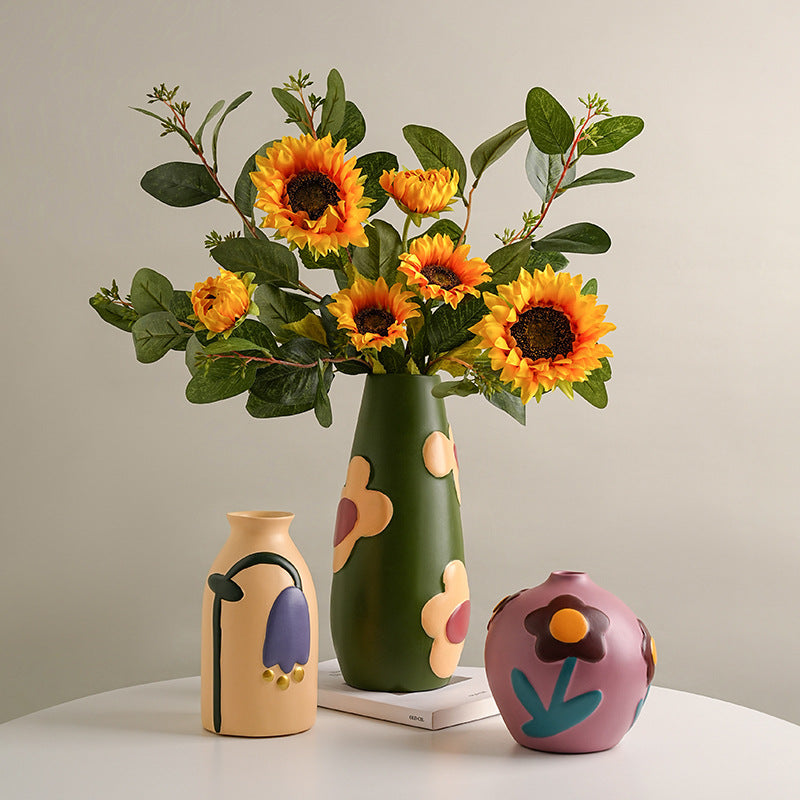 Colorful retro ceramic vase trio with sunflower and mixed flower arrangement