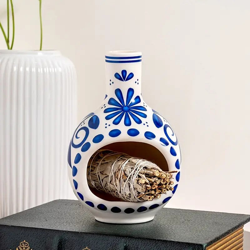 Blue and white porcelain style sacred wood burner holding sage bundle