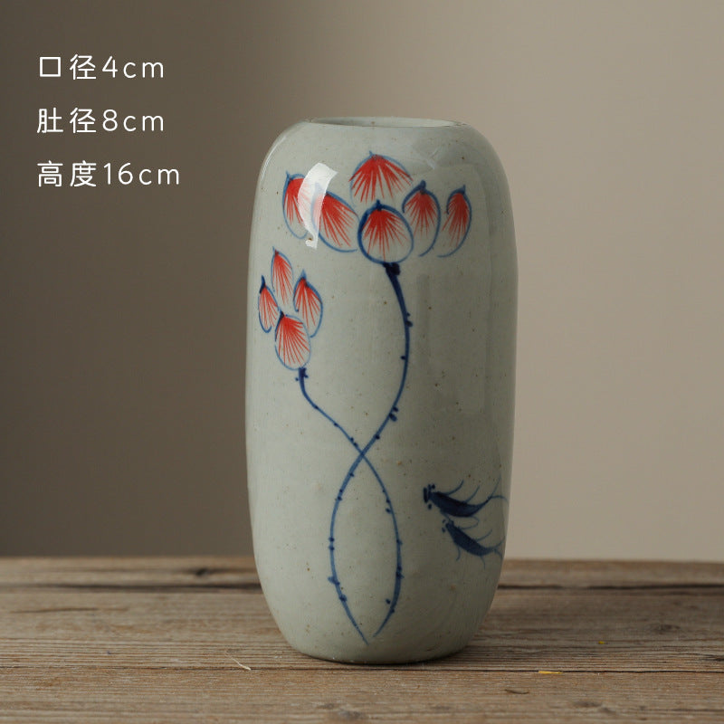 Hand-painted blue white ceramic bud vase with lotus and bird motif, 16 cm