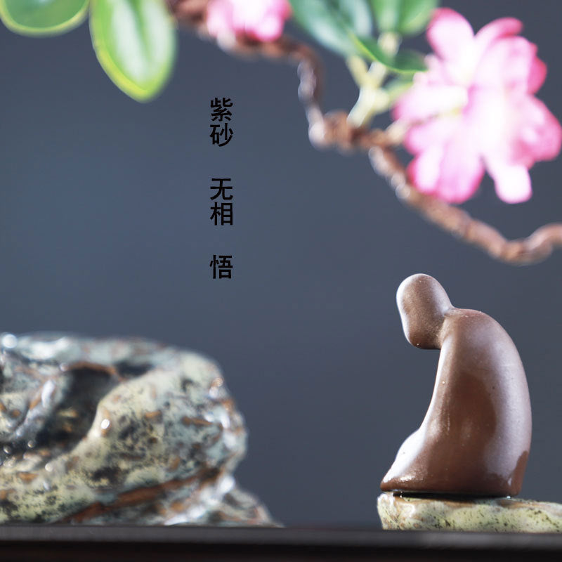 Zen scholar figure beside flowering branch and rock fountain landscape