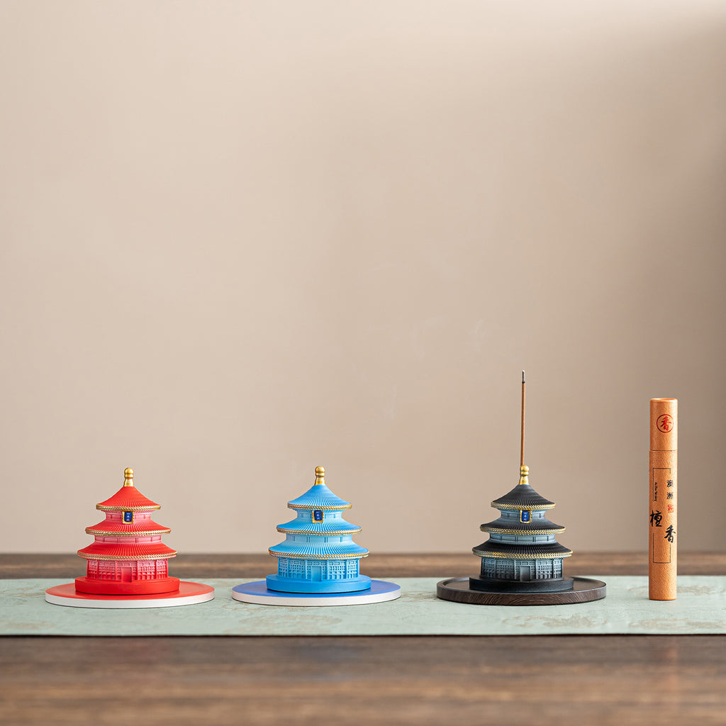 Red blue and black Temple of Heaven incense holders displayed with sandalwood incense