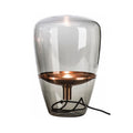 Smoke grey capsule glass table lamp with black metal accessories and warm glow