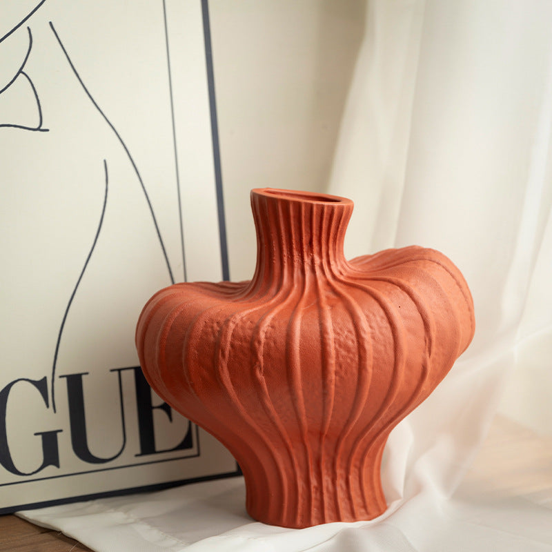 Terracotta red sculptural ribbed ceramic vase in wabi-sabi interior