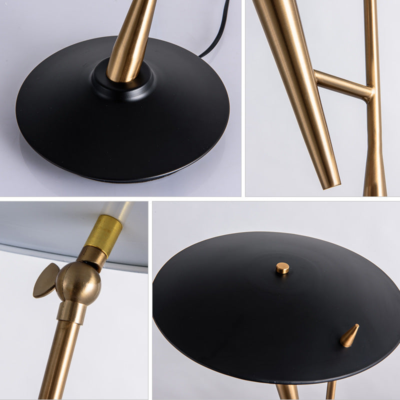 Sculptural balance table lamp with black blade form and brass support