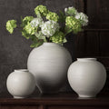 White ribbed round ceramic vase trio styled with green hydrangeas